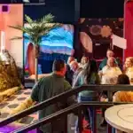 Indoor entertainment area at Albatross with themed decor and guests enjoying activities.